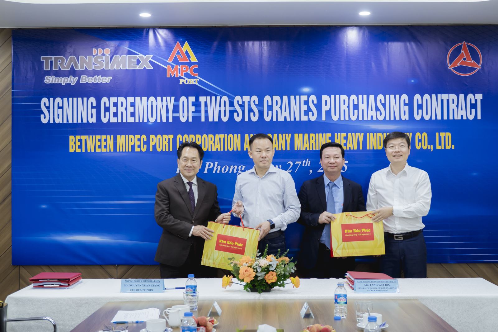 A group of men standing in front of a bannerAI-generated content may be incorrect.